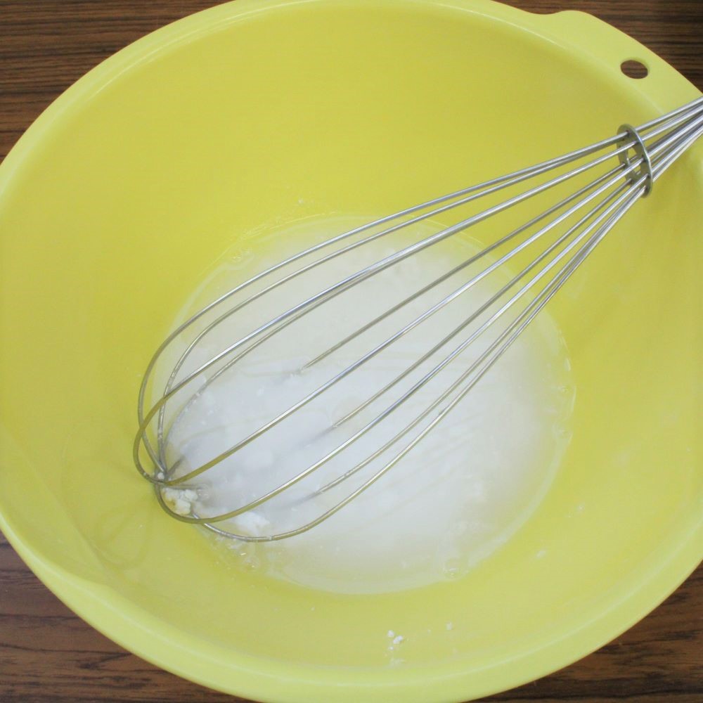 ボウルに白玉粉を入れ、水を少量ずつ数回に分けて加え、泡立て器で混ぜ合わせます。